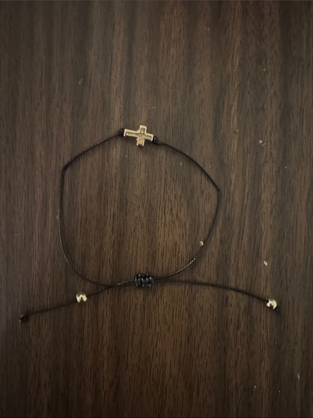 Source Unknown Gold Cross on Black Cord Adjustable Bracelet